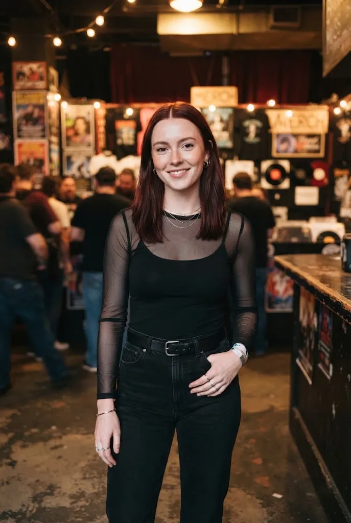 Woman in her 20s wearing a mesh long sleeve top layered under a cami